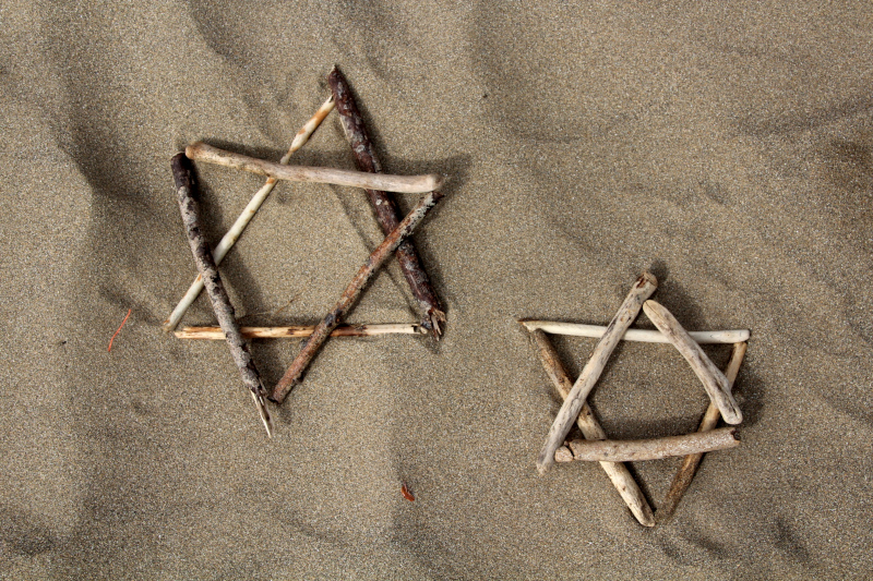 two triangles each made of three sticks placed on top of one another to make a star